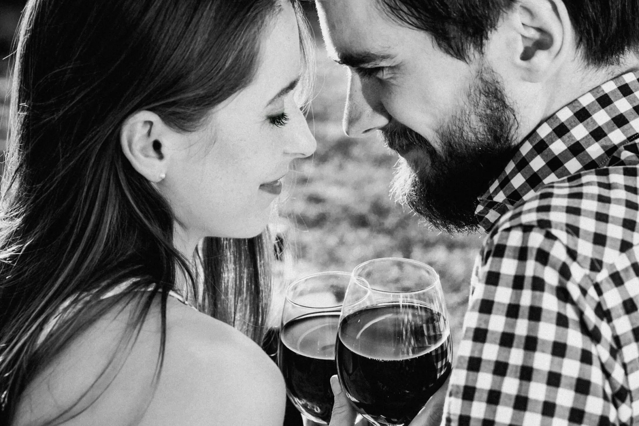 Couple sharing a romantic moment with wine glasses.
